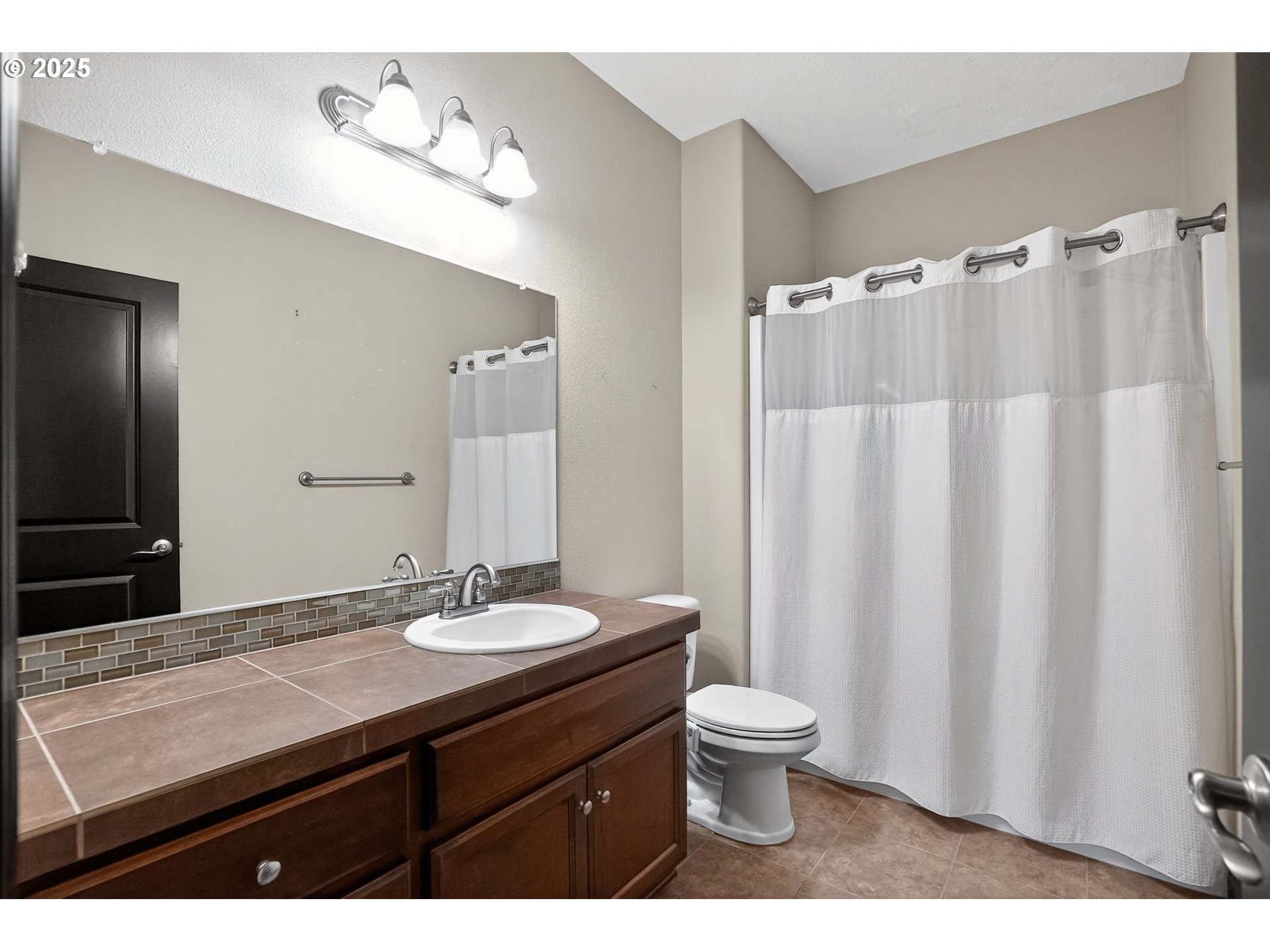 18740 South Upper Highland Road Beavercreek, OR 97004 - Photo 28 of 48 a bathroom with a granite countertop sink toilet and a mirror