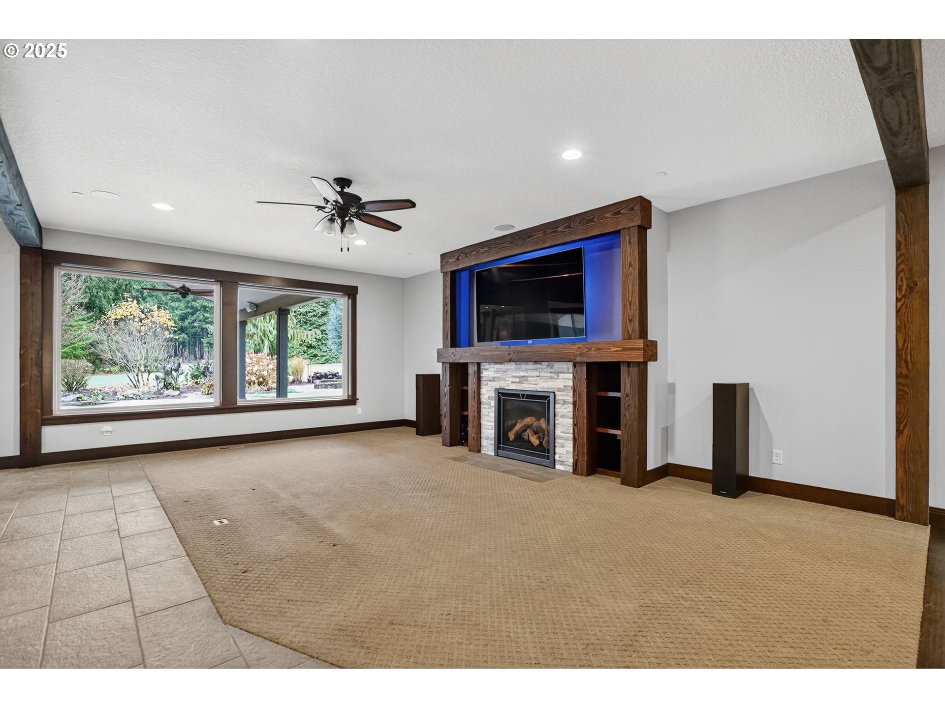 18740 South Upper Highland Road Beavercreek, OR 97004 - Photo 8 of 48 a view of an empty room with a fireplace and a window