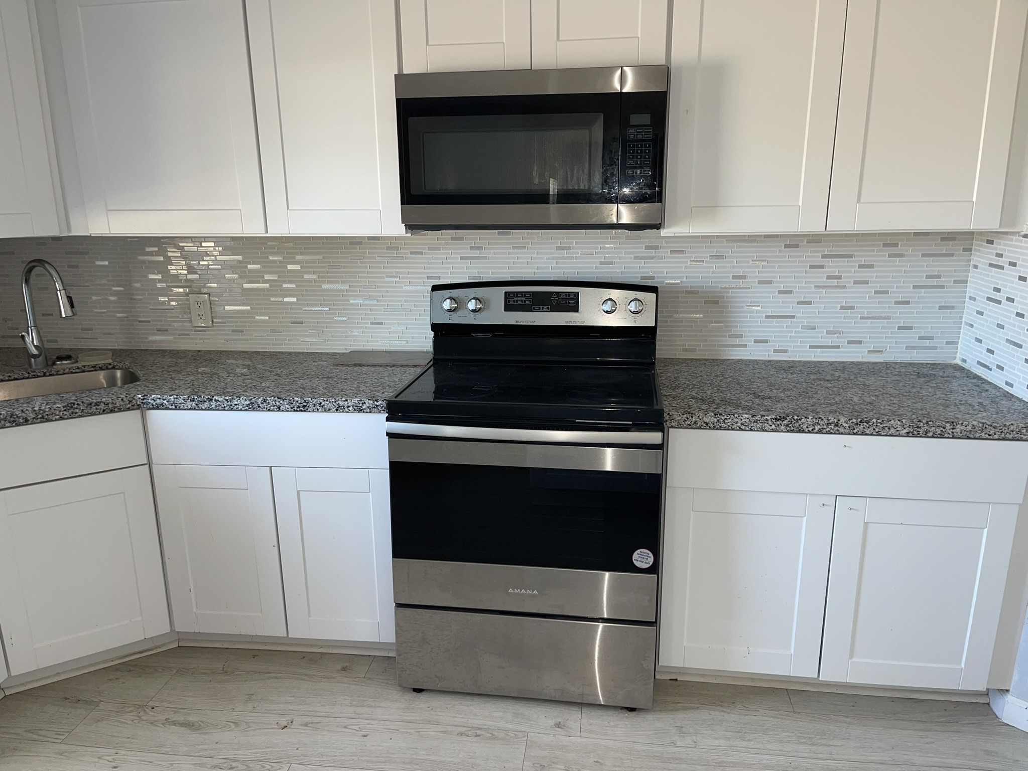 17202 Sunshine Street Houston, TX 77049 - Photo 7 of 19 a kitchen with stainless steel appliances granite countertop a stove microwave and sink