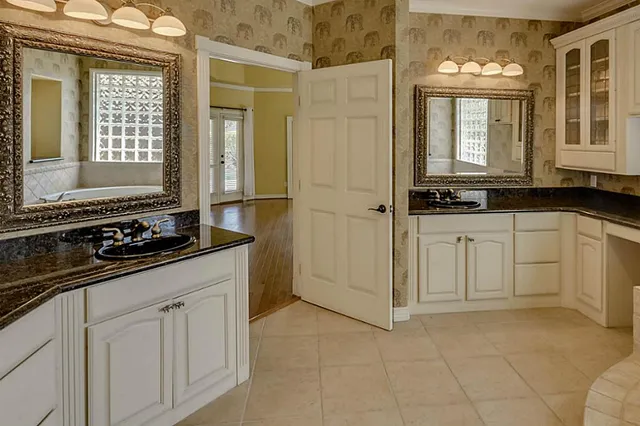 a bathroom with a tub a sink and a shower