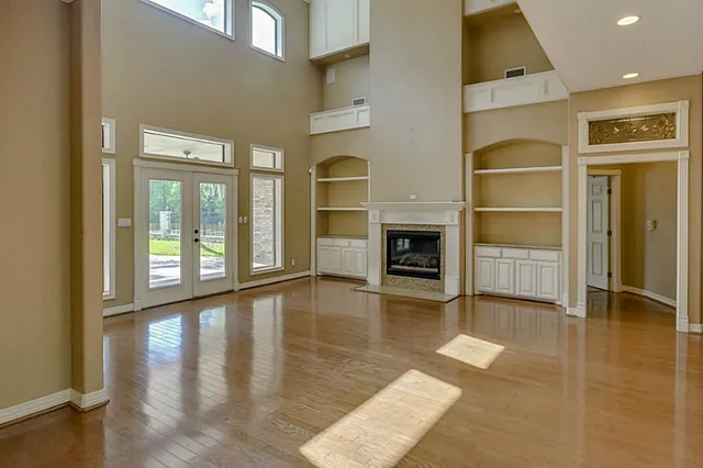 a view of a hallway with entryway wooden floor and front door