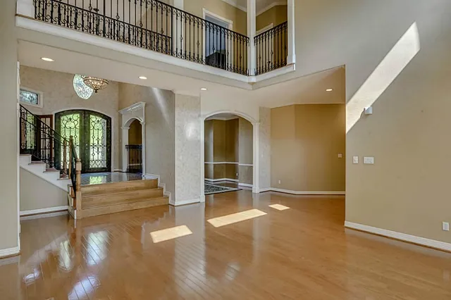 a view of an empty room with stairs and a fireplace