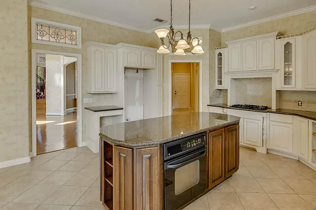 a kitchen with stainless steel appliances granite countertop a sink and cabinets