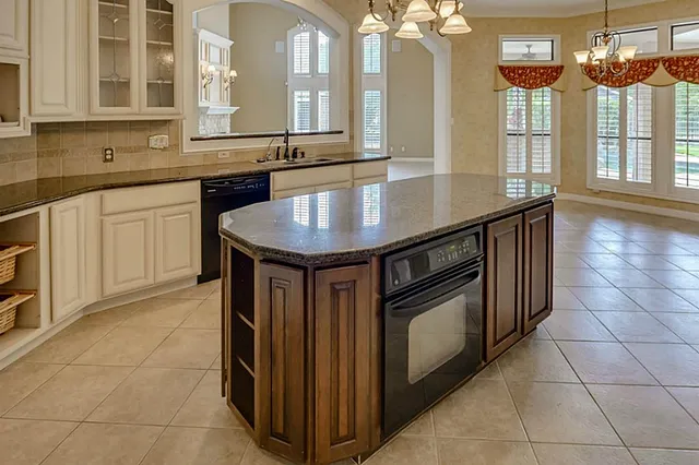 a view of an empty room with a fireplace and a window