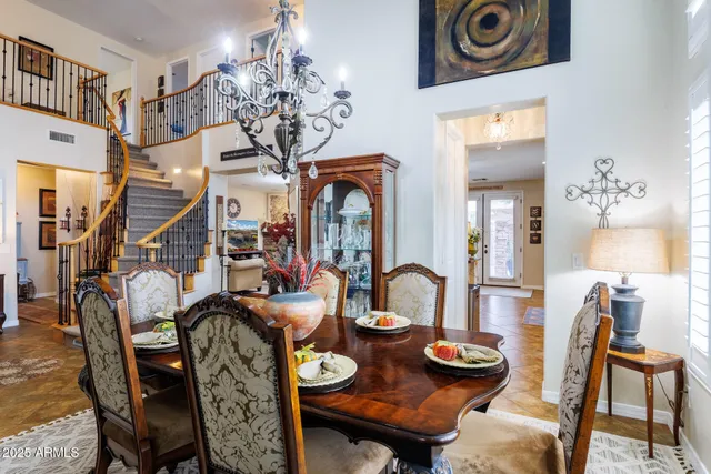 a living room with furniture a chandelier a fireplace and a large window