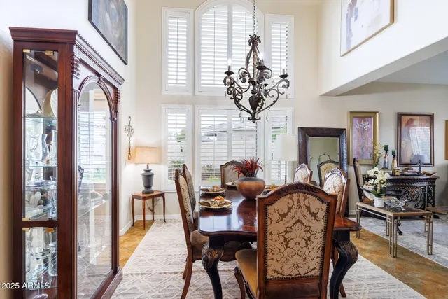 a living room with furniture a chandelier and a fireplace