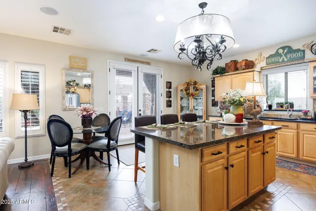 a kitchen with stainless steel appliances granite countertop a refrigerator and a stove
