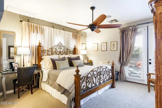 a bedroom with a bed and a chandelier