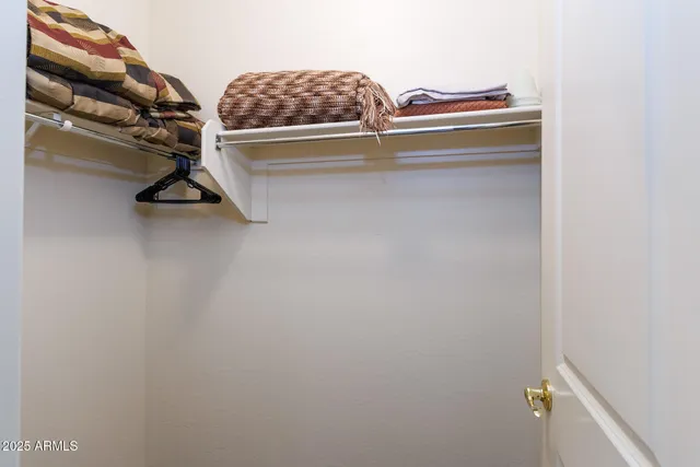 an aerial view of a house with garden space and a car parked in the background