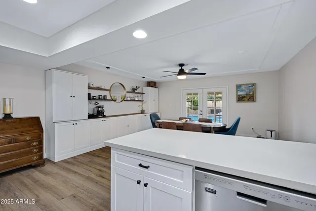 a kitchen with a refrigerator and white cabinets