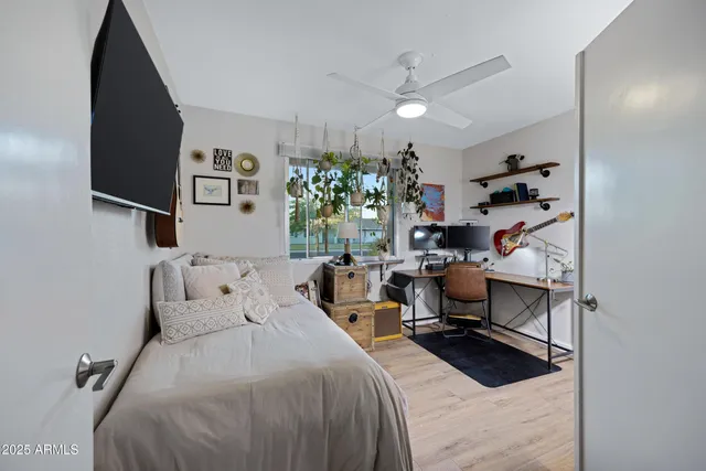 a bedroom with a bed and a chandelier