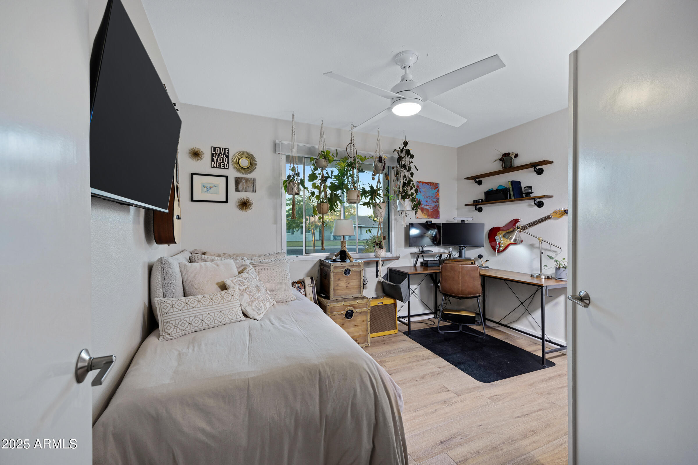 1824 West Seldon Lane Phoenix, AZ 85021 - Photo 14 of 34 a bedroom with a bed and a chandelier