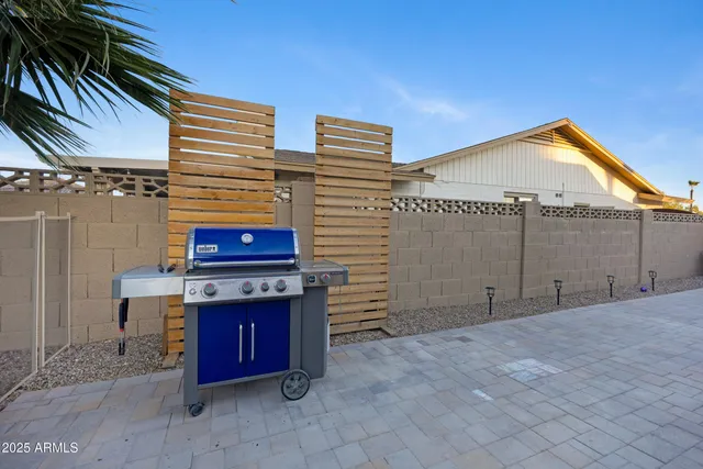 a view of a patio with table and chairs potted plants with wooden floor and fence