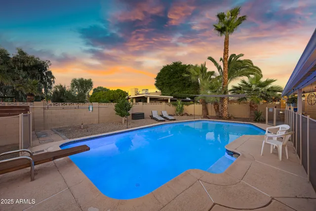 a view of a swimming pool with a table and chairs
