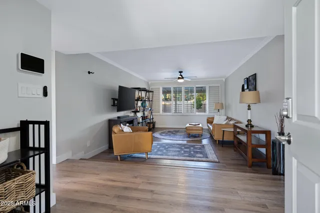 a living room with dining room and wooden floor