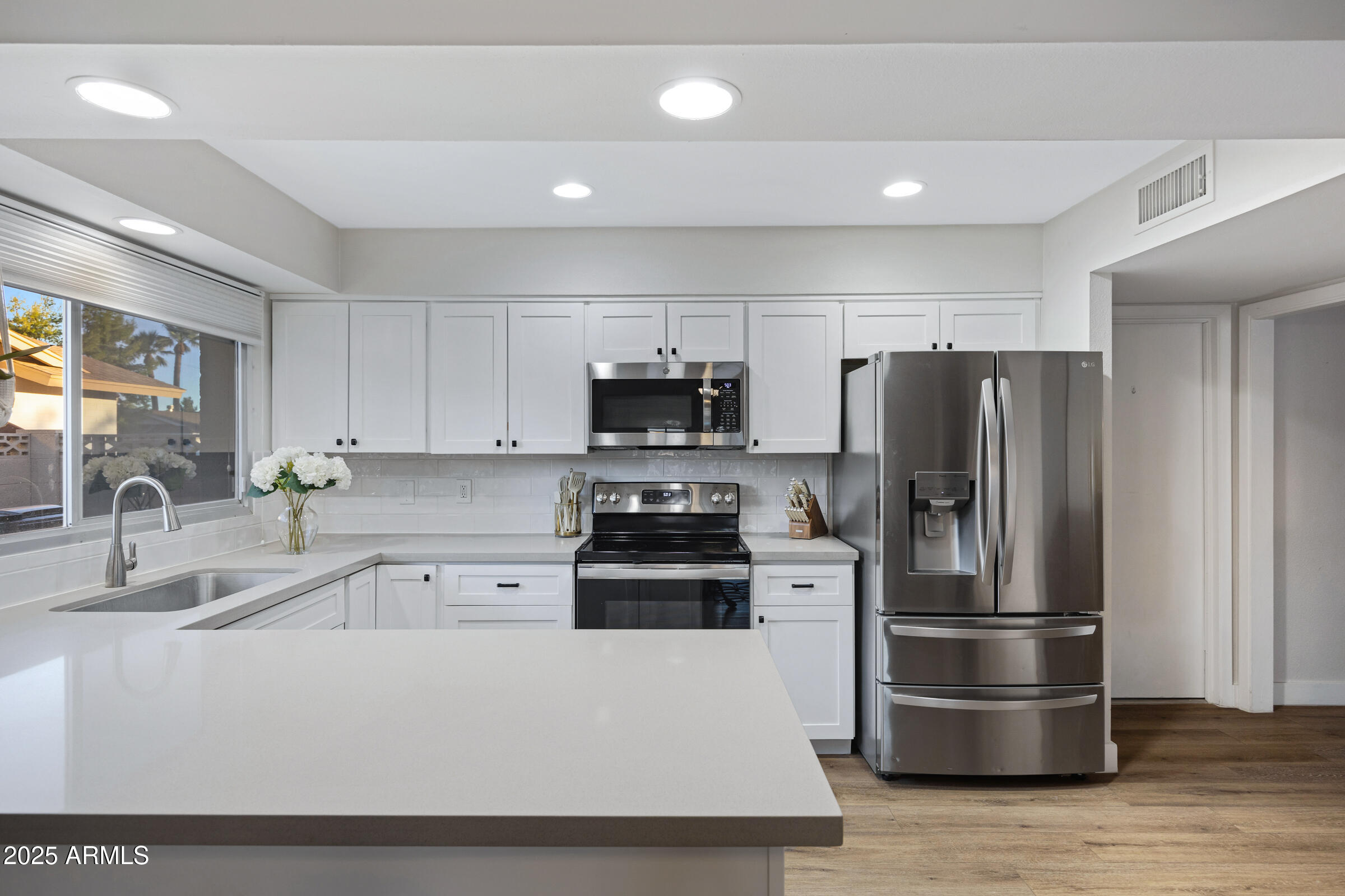 1824 West Seldon Lane Phoenix, AZ 85021 - Photo 8 of 34 a kitchen with stainless steel appliances a refrigerator a stove a sink and a granite counter tops