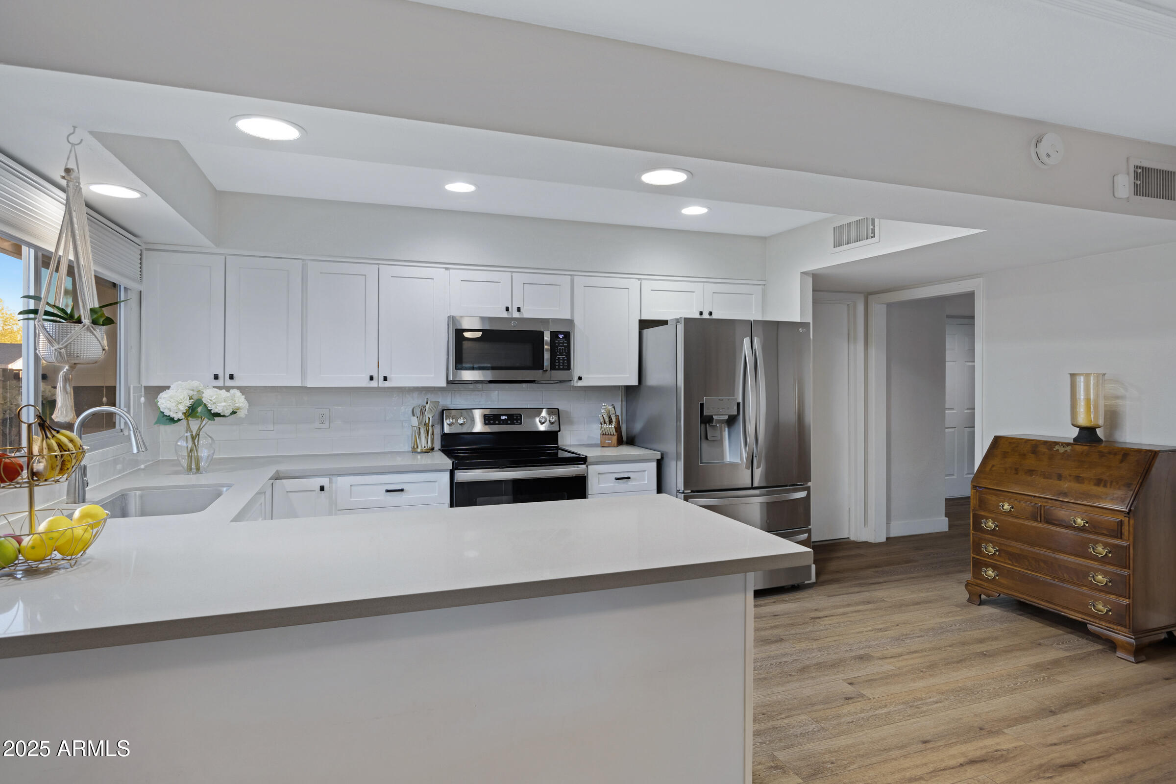 1824 West Seldon Lane Phoenix, AZ 85021 - Photo 9 of 34 a kitchen with a refrigerator and a stove top oven