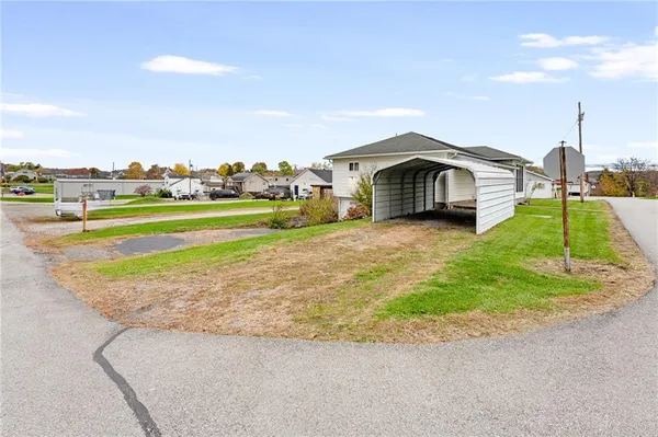 a view of a house with a yard and sitting area
