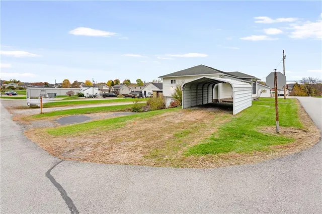 a view of a house with a yard and sitting area