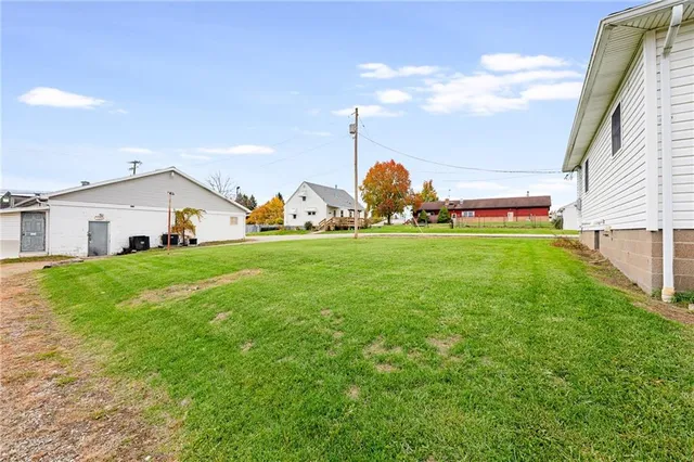 a view of a house with a yard and sitting area