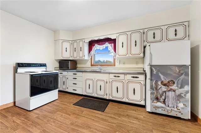 a kitchen with stainless steel appliances a white stove top oven and a sink