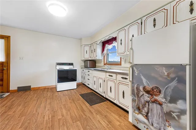 a kitchen with stainless steel appliances granite countertop a stove and a wooden floors