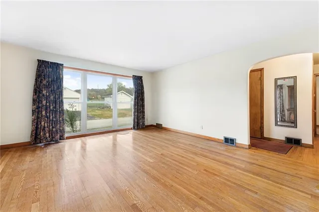 an empty room with wooden floor and closet