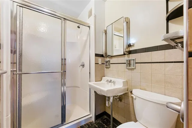 an empty room with wooden floor and closet area