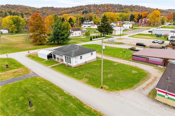 an aerial view of a house with a swimming pool