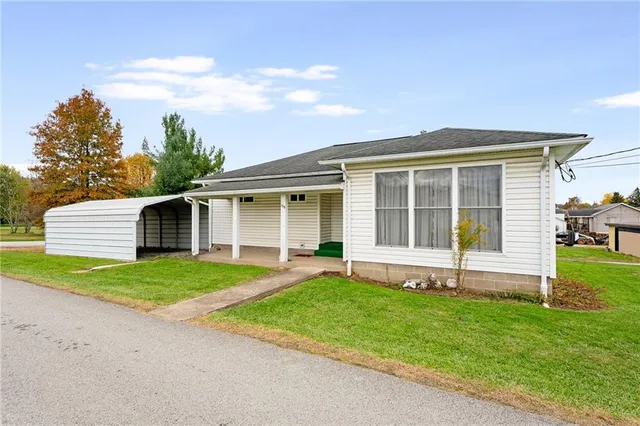 a front view of a house with a garden and yard