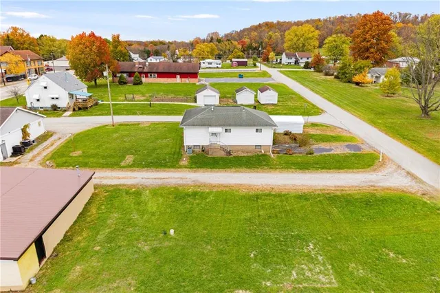 a white bench sitting in the middle of a park