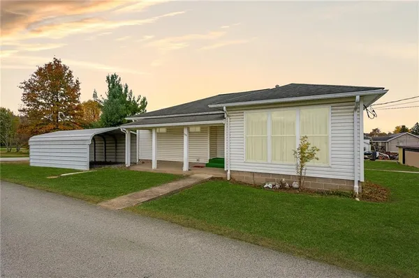 a front view of a house with a garden