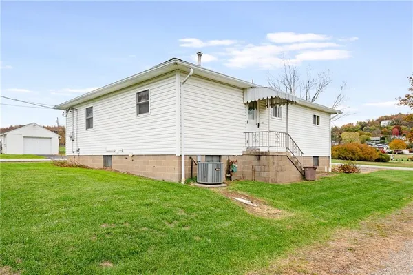 a view of a house with a yard and a porch