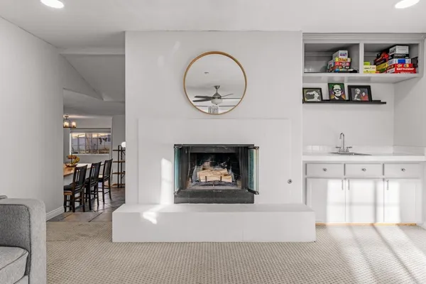 a living room with furniture a window and a fireplace