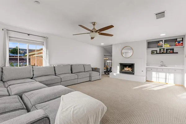 a living room with furniture a window and a fireplace