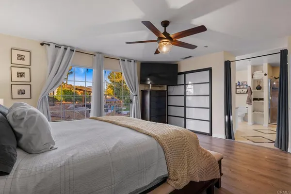 a bedroom with a large bed and a large window