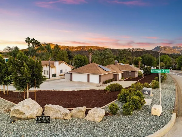 a view of a house with a yard and sitting area