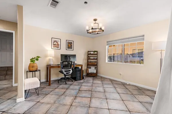 a view of a livingroom with furniture and workspace