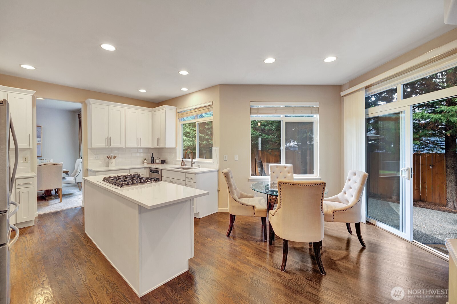 3208 175th Street Southeast Bothell, WA 98012 - Photo 11 of 34 a kitchen with a sink and chairs