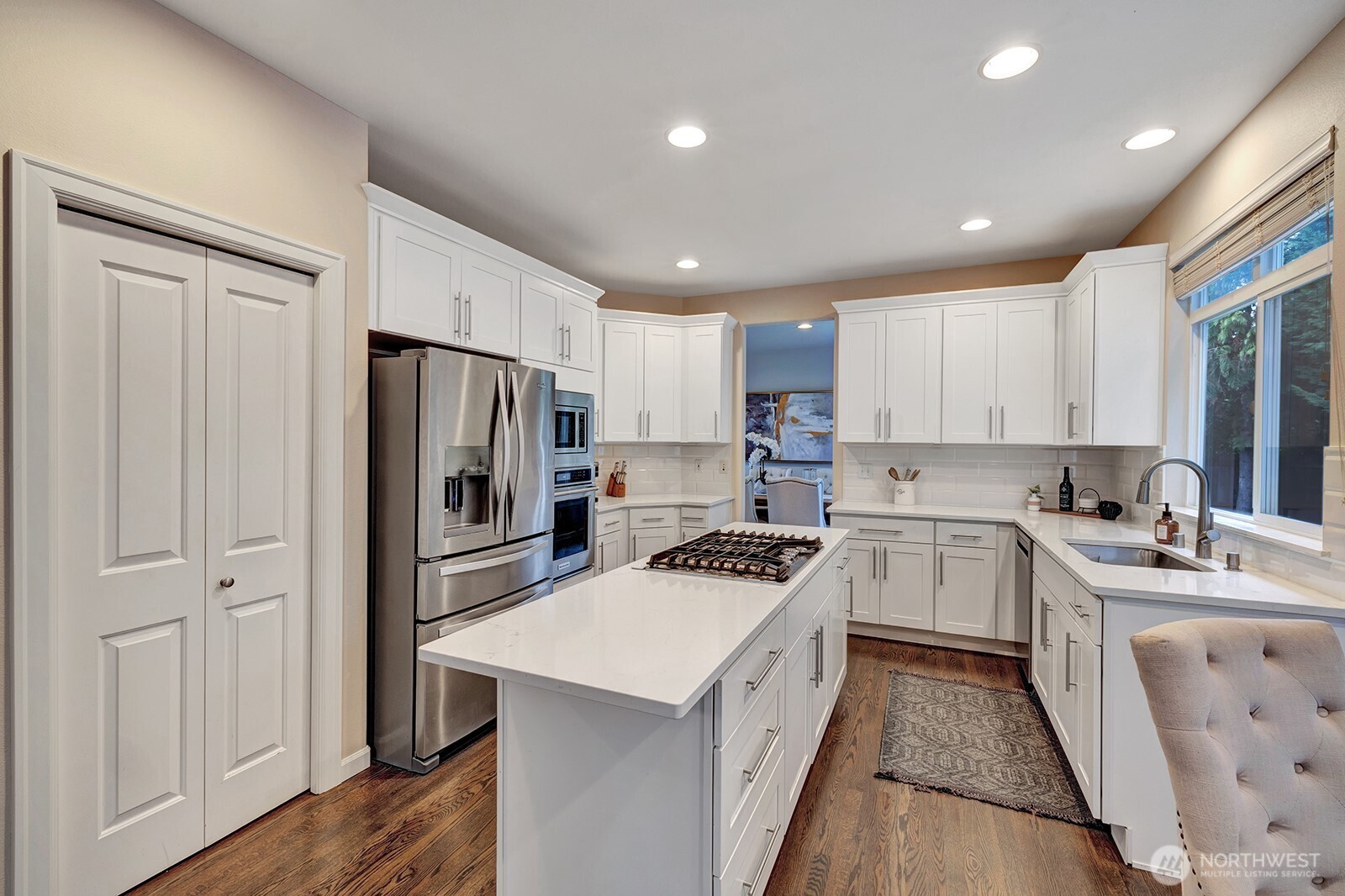 3208 175th Street Southeast Bothell, WA 98012 - Photo 13 of 34 a kitchen with a sink a stove a refrigerator a center island and a window