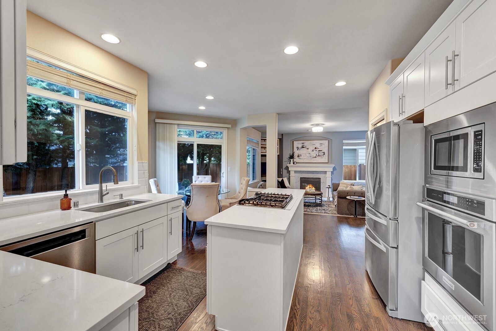 3208 175th Street Southeast Bothell, WA 98012 - Photo 14 of 34 a large kitchen with stainless steel appliances lots of counter space and wooden floors