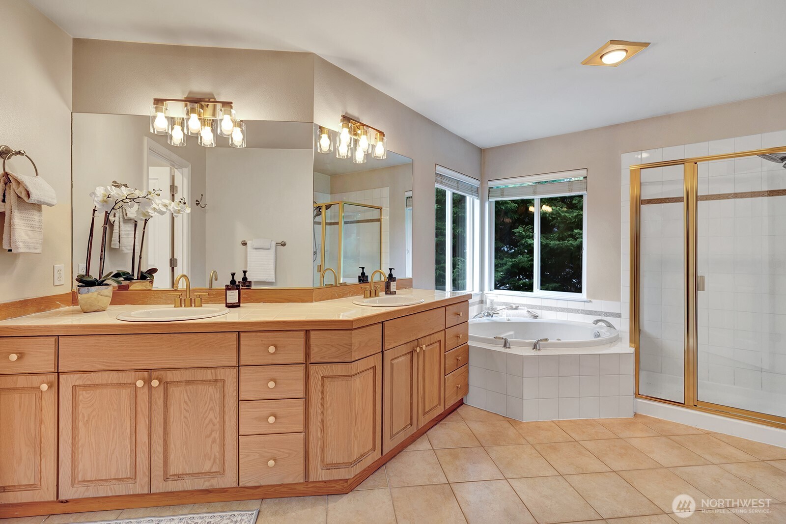 3208 175th Street Southeast Bothell, WA 98012 - Photo 22 of 34 a spacious bathroom with a granite countertop double vanity sink a mirror and a bathtub