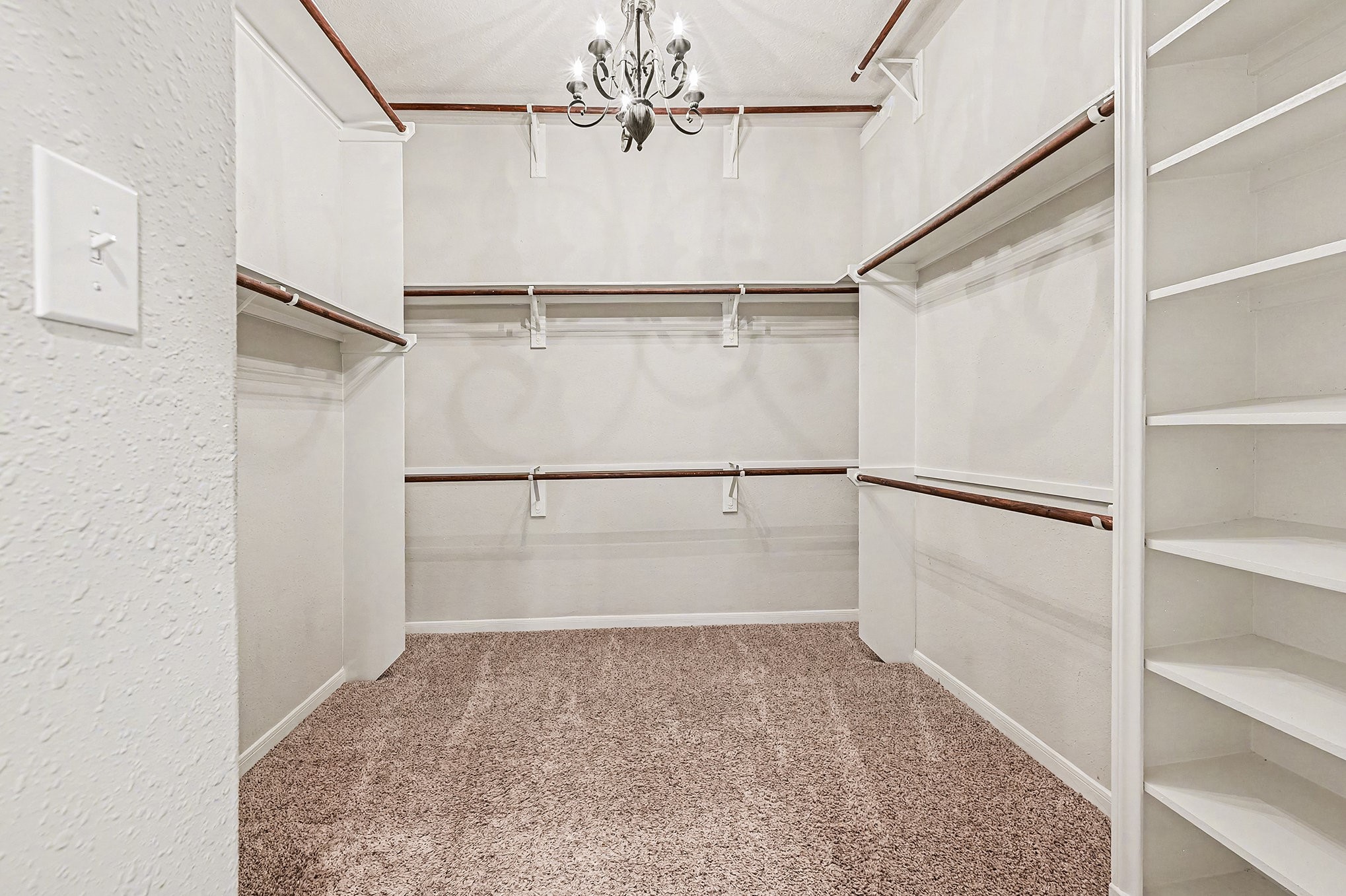 4402 Eden Point Lane Katy, TX 77494 - Photo 20 of 39 Look at 1 of 2 closets In Primary Bathroom (10.5 x 10.5) lots of shelfing, hanging space for all clothes and shoes with a chandlier for lighting.