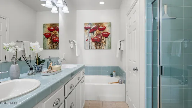 a bathroom with a sink a bath tub and a mirror