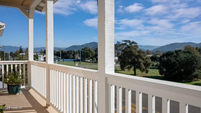 a view of a balcony with wooden fence and floor