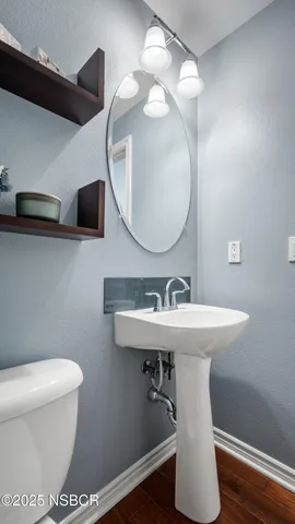 a bathroom with a sink a mirror and a toilet
