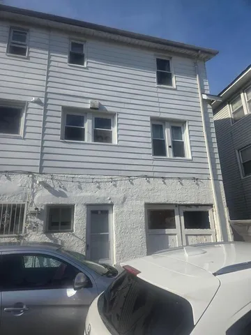 a view of a house with a car parked in front of it