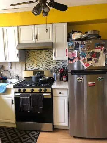 a kitchen with stainless steel appliances granite countertop a stove and a sink