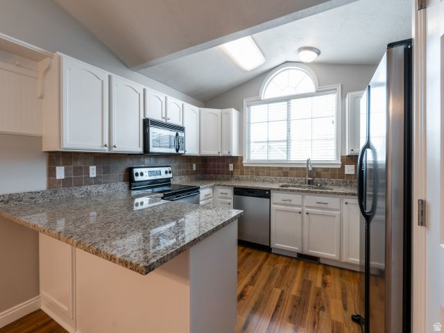 1446 West 1450 North Layton, UT 84041 - Photo 3 of 16 Kitchen featuring white cabinetry, granite countertops, a tiled backsplash, wood-finish flooring, and stainless steel appliances