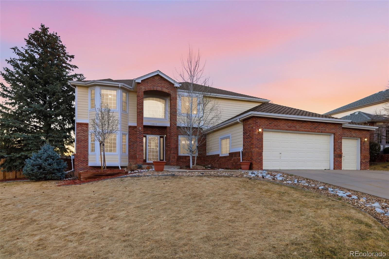 10917 Ammons Street Broomfield, CO 80021 - Photo 2 of 47 a front view of a house with a yard